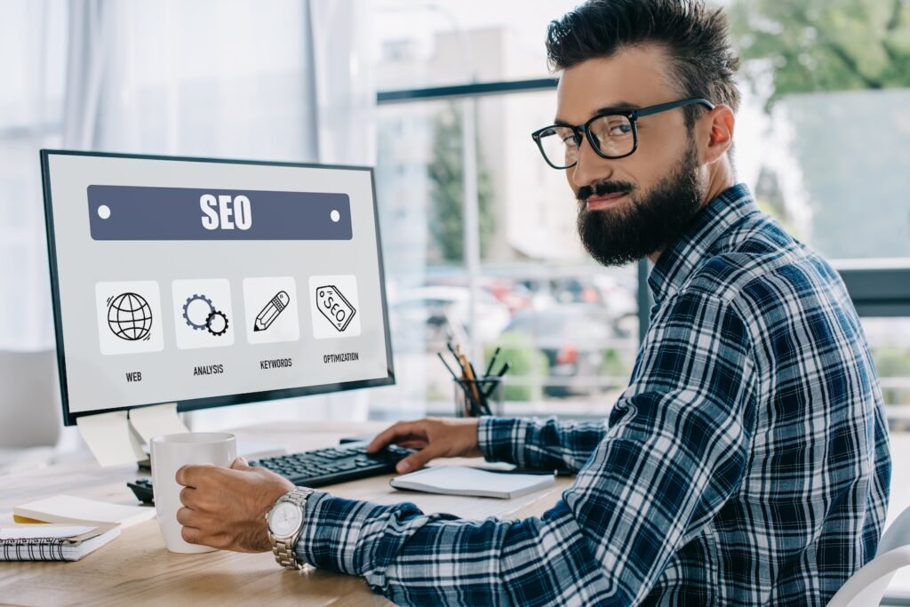 Beginner’s Guide to Local SEO for Small Businesses 1 Local SEO tips for small businesses - image of a man doing SEO work on a computer